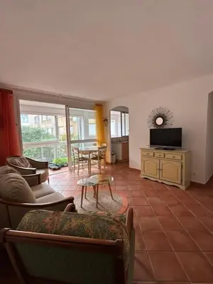 a living room with a couch and a table at T3 Ajaccio rte des Sanguinaires in Ajaccio