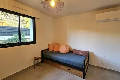 a room with a bed with pillows and a window at Nouveau Superbe appartement - Rsd Calypso Tiuccia in Casaglione