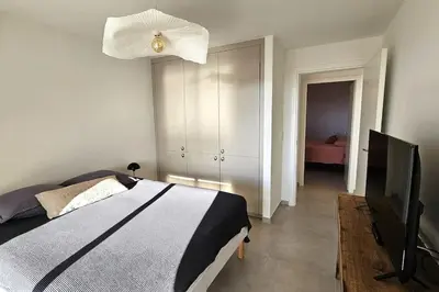 a bedroom with a bed and a ceiling fan at Nouveau Superbe appartement - Rsd Calypso Tiuccia in Casaglione
