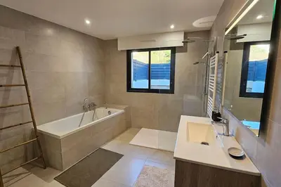 a bathroom with a tub and a sink and a bath tub at Nouveau Superbe appartement - Rsd Calypso Tiuccia in Casaglione