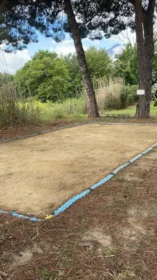 a blue line on the ground next to two trees at A CASA DI SPIAGGIA in San-Nicolao