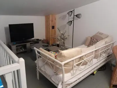 a living room with a couch and a tv at A CASA DI SPIAGGIA in San-Nicolao
