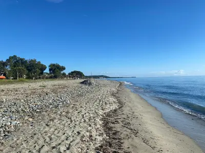 a beach with rocks and the ocean on a clear day at A CASA DI SPIAGGIA in San-Nicolao