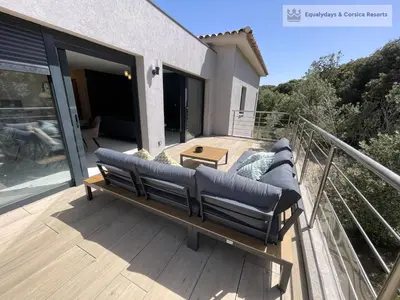 a bench on the deck of a house at Bonifacio Les Jardins secrets de Piale in Bonifacio