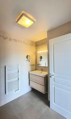 a bathroom with a sink and a mirror at Studio 2 avec piscine & vue sur la baie d'Ajaccio in Alata