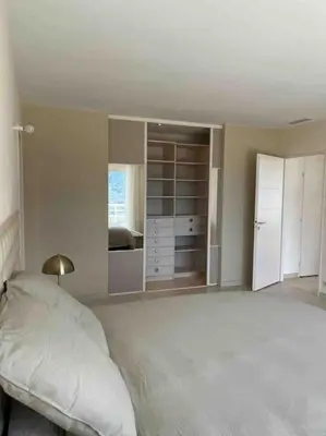 a white bedroom with a bed and a closet at Casa Antonietta Alata vue imprenable sur la mer in Alata