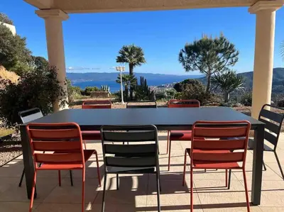 a table and chairs on a patio with a view at Casa Antonietta Alata vue imprenable sur la mer in Alata