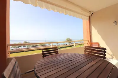 a dining room table with a view of the ocean at T2 ARIA MARINA Route des Sanguinaires, Vue MER, Terrasse , Parking, Plage à 50M - 4pers in Ajaccio