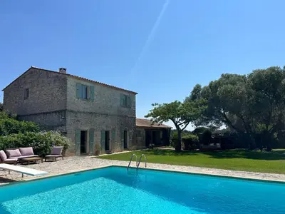 a house with a swimming pool in front of a building at Château Balesi Bonifacio in Bonifacio