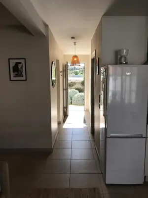 a hallway with a white refrigerator in a house at Appartement bord de mer T4 marina di bravonne N5-6 in Linguizzetta