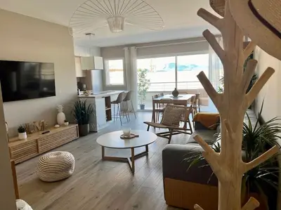 a living room with a couch and a table at joli T4 centre ville Porticcio in Grosseto-Prugna