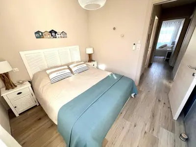 a bedroom with a large bed and a bathroom at joli T4 centre ville Porticcio in Grosseto-Prugna
