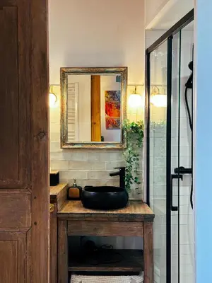 a bathroom with a sink and a mirror at Casaluna, centre village, joli petit studio in Sotta