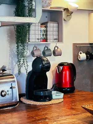 a kitchen counter with a coffee maker and a toaster at Casaluna, centre village, joli petit studio in Sotta