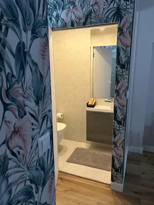 a bathroom with a toilet and a sink and a mirror at Appartement au centre du Port de Bonifacio in Bonifacio