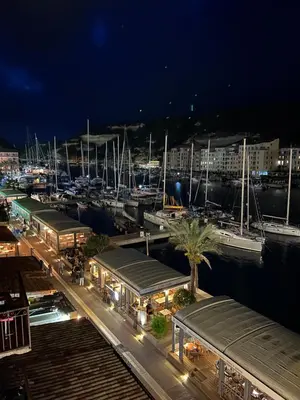 a marina at night with boats in the water at Appartement au centre du Port de Bonifacio in Bonifacio