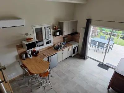 a kitchen with a table and a sink and a table at A Casetta in Prunelli-di-Fiumorbo