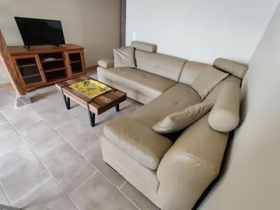 a living room with a couch and a table at A Casetta in Prunelli-di-Fiumorbo