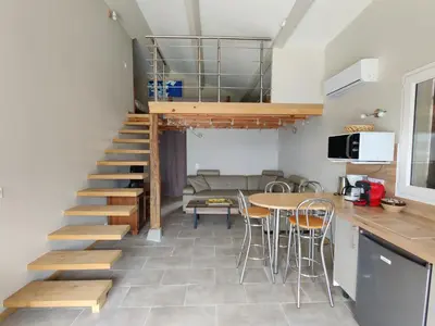 a staircase in a kitchen with a table and chairs at A Casetta in Prunelli-di-Fiumorbo
