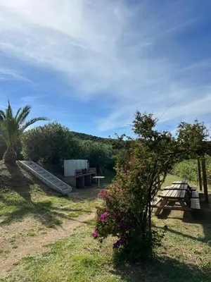 a park with a picnic table and a bench and flowers at Lavallee4 in Belvédère