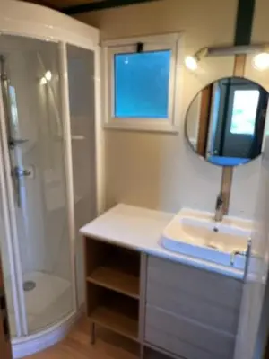 a bathroom with a shower and a sink and a mirror at Lavallee4 in Belvédère