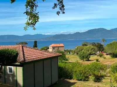 a house with a view of the water and mountains at Lavallee4 in Belvédère