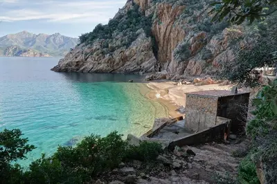 a beach with blue water and a mountain at Superbe appartement 3 chambres avec Grande Terrasse in Pietrosella