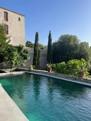 a swimming pool in a yard with trees and a building at Domaine du Couvent de Saint Julien in Bonifacio
