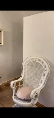 a white chair with a pink seat in a room at Domaine du Couvent de Saint Julien in Bonifacio