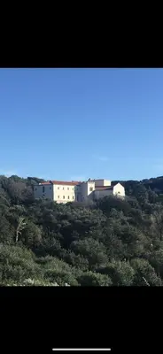 a group of white buildings on top of a hill at Domaine du Couvent de Saint Julien in Bonifacio