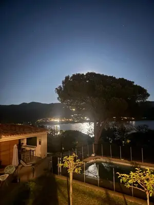 a view of a house and a tree at night at A Pineta Corsa in Pietrosella