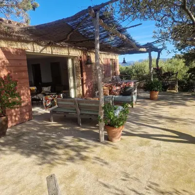 a porch of a house with a bench at Tizzano, villa vue mer avec piscine in Sartène