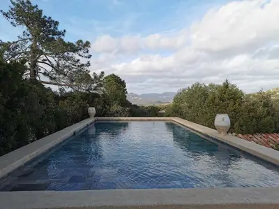 a swimming pool with a view of the mountains at Tizzano, villa vue mer avec piscine in Sartène