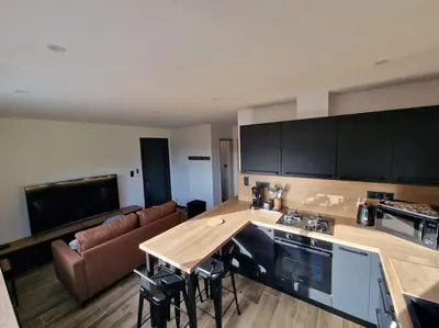 a kitchen with a couch and a table in a room at Belle villa à la campagne dans un coin cosy in Sartène