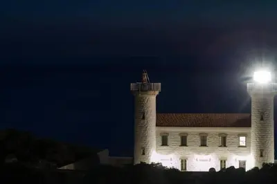 a building with a light on top of it at night at Belle villa à la campagne dans un coin cosy in Sartène