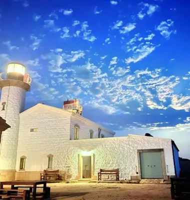 a lighthouse sitting next to a white building at Belle villa à la campagne dans un coin cosy in Sartène