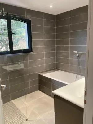 a bathroom with a shower and a tub and a sink at Villa 4 personnes - 2 chambres - Figari in Figari