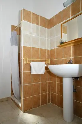a bathroom with a sink and a shower at Villa CASA CALLISTA , confort et calme in Sainte-Lucie de Porto-Vecchio
