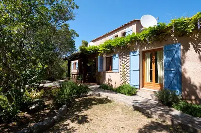 a house with ivy on the side of it at Villa CASA CALLISTA , confort et calme in Sainte-Lucie de Porto-Vecchio