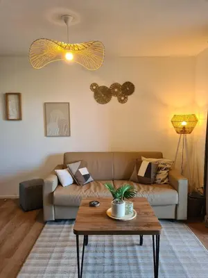 a living room with a couch and a table at Superbe T2 neuf 42m² Cala Rossa (proche mer) in Lecci