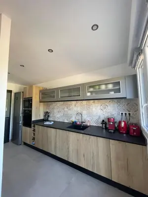 a kitchen with a black counter top in a room at Maison neuve Porto Vecchio in Porto-Vecchio