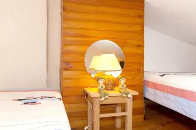 a room with two beds in a room at Appartement charmant avec piscine à Porticcio - 32 m² in Porticcio