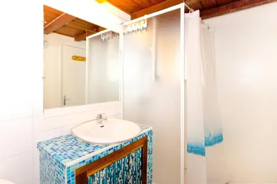 a bathroom with a sink and a mirror at Appartement charmant avec piscine à Porticcio - 32 m² in Porticcio