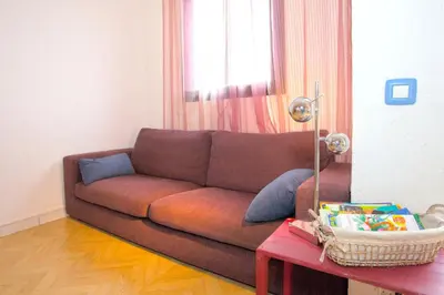 a kitchen and dining room with a loft bed and a table at Appartement charmant avec piscine à Porticcio - 32 m² in Porticcio