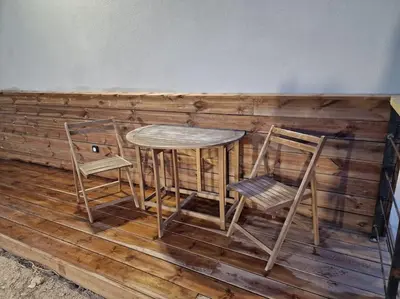 a table and two chairs sitting on a wooden floor at Belle villa à la campagne dans un coin cosy in Sartène