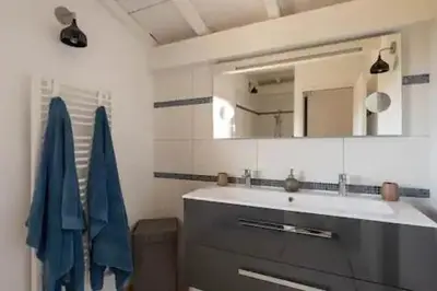 a bathroom with a sink and a mirror at VILLA MYRTE A CIRINDINU in Cirendinu