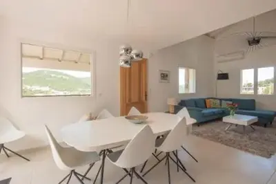 a living room with a white table and white chairs at VILLA MYRTE A CIRINDINU in Cirendinu