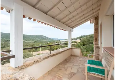 a balcony with a bench and a view at VILLA MYRTE A CIRINDINU in Cirendinu