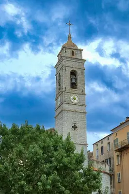 a clock tower with a cross on top of it at Fiori Di Cala Rossa, Établissement CARDOGA Piscine, Mer & Montagne in Lecci