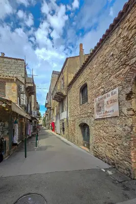 an alley in an old stone building with a sign on it at Fiori Di Cala Rossa, Établissement CARDOGA Piscine, Mer & Montagne in Lecci